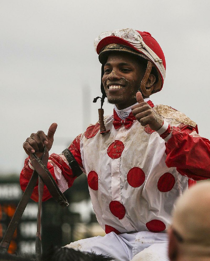 Ricardo Santana Jr. celebrates after riding Unbridled Mo to victory in the Apple Blossom Handicap at Oaklawn Park in Hot Springs on Friday. 

