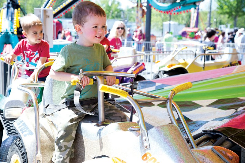 Xander Johnson, 2, takes a ride at the Cabot Strawberry Festival last year. The festival, which will begin on Thursday and last till Saturday, is organized and run by the Junior Auxiliary of Cabot.