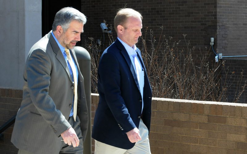 Greg Payne (left), attorney with the Story Law Firm, walks April 4 with Oren Paris III, president of Ecclesia College, as they leave the John Paul Hammerschmidt Federal Building in Fayetteville.