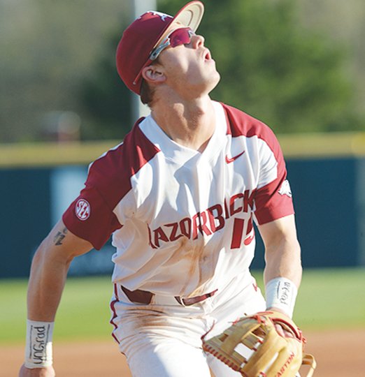 NWA Democrat-Gazette/Andy Shupe GOT IT COVERED: Arkansas third baseman Casey Martin tracks down a fly ball Thursday in the first inning of the Razorbacks' 3-2 loss to South Carolina at Baum Stadium in Fayetteville.