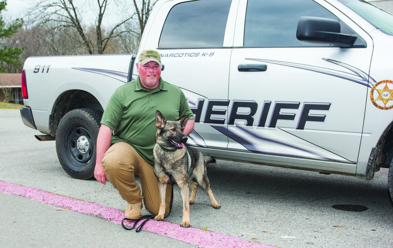 Deputy Jeff McLain of the Cleburne County Sheriff’s Office poses with new K-9 dog Xinie, who was put into service in December. Xinie is a German shepherd who came to Arkansas from the Czech Republic.