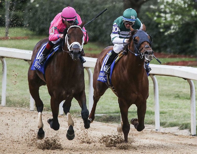 City of Light, ridden by Drayden Van Dyke (left), edges out Accel-erate, ridden by Victor Espinoza, to win the Oaklawn Handicap at Oaklawn Park in Hot Springs on Saturday.