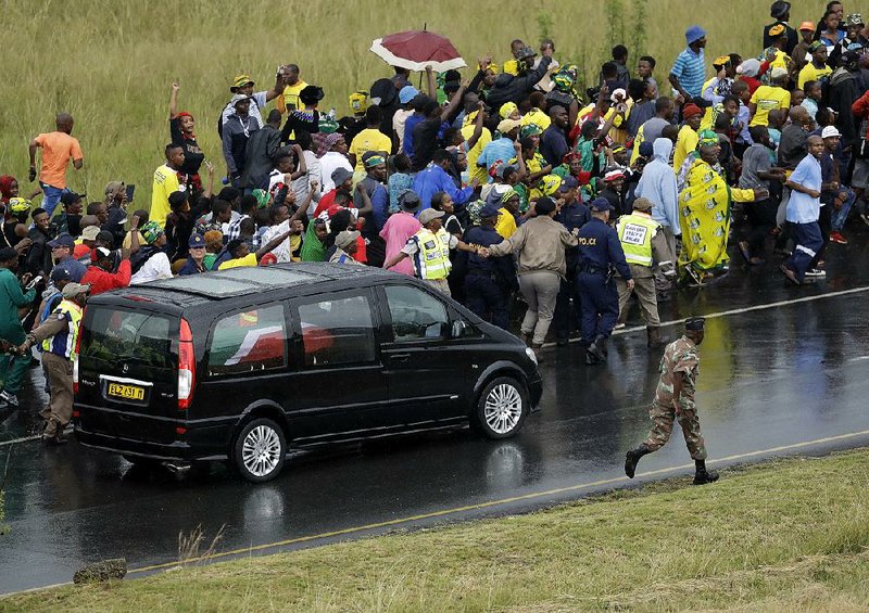 People follow the hearse carrying the coffin of anti-apartheid activist Winnie Madikizela-Mandela after her funeral Saturday in Soweto, South Africa.  