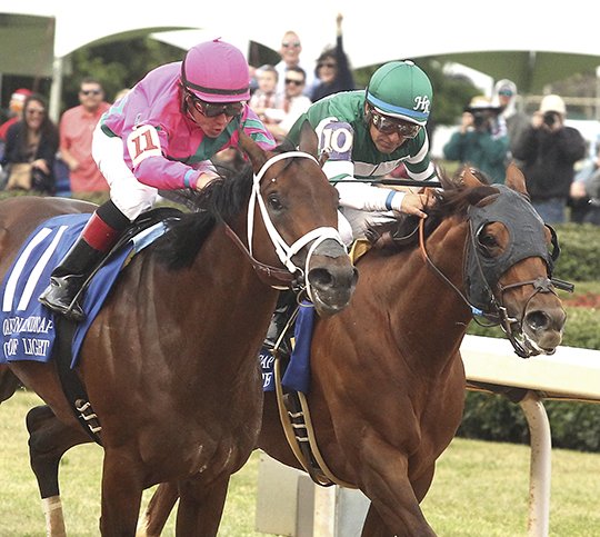 The Sentinel-Record/Richard Rasmussen GUIDING LIGHT: Jockey Drayden Van Dyke guides City of Light (11), left, across the wire Saturday at Oaklawn Park to beat Accelerate and jockey Victor Espinoza to win the Grade 2 $750,000 Oaklawn Handicap for older horses.