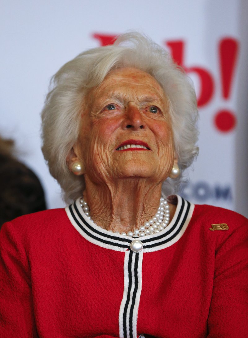 File-This Feb. 19, 2016, file photo shows former first lady Barbara Bush listening to her son, Republican presidential candidate, former Florida Gov. Jeb Bush speak during a campaign stop at Wade's Restaurant, in Spartanburg, S.C. The former First Lady is making sure to keep her alma mater up to date on what’s going on in her world. The Boston Globe reports that Bush wrote a dispatch for Smith College’s alumnae magazine this month. She says: “I am still old and still in love with the man I married 72 years ago.” Bush dropped out of Smith College in 1944 and married George H.W. shortly after. The school awarded her an honorary degree in 1989. (AP Photo/Paul Sancya, File)