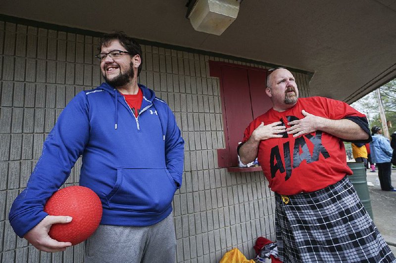 Zachary Booe (left) of North Little Rock and Mo Sliger of Cabot talk about Margie Ashcraft, a kickball teammate who was killed earlier this year. The team, Team Francis, held a fundraiser for her family before their game at Interstate Park in Little Rock on Sunday.