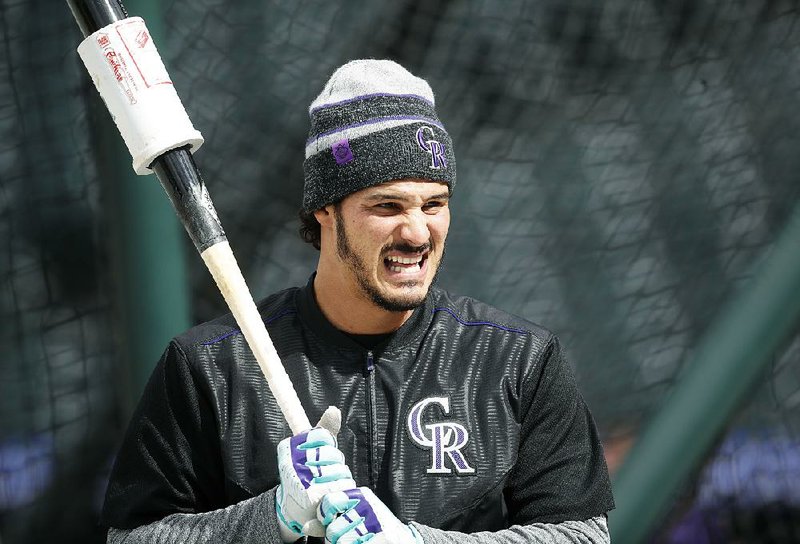 Colorado Rockies' Nolan Arenado waits to take swings in the cage during batting practice before facing the Atlanta Braves in a baseball game Saturday, April 7, 2018, in Denver. 