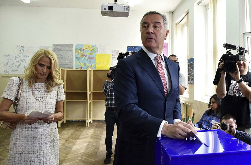 Milo Djukanovic, leader of Montenegro’s ruling Democratic Party of Socialists, and wife Lidija cast their ballots Sunday at the polling station in the capital, Podgorica, during the country’s presidential election.