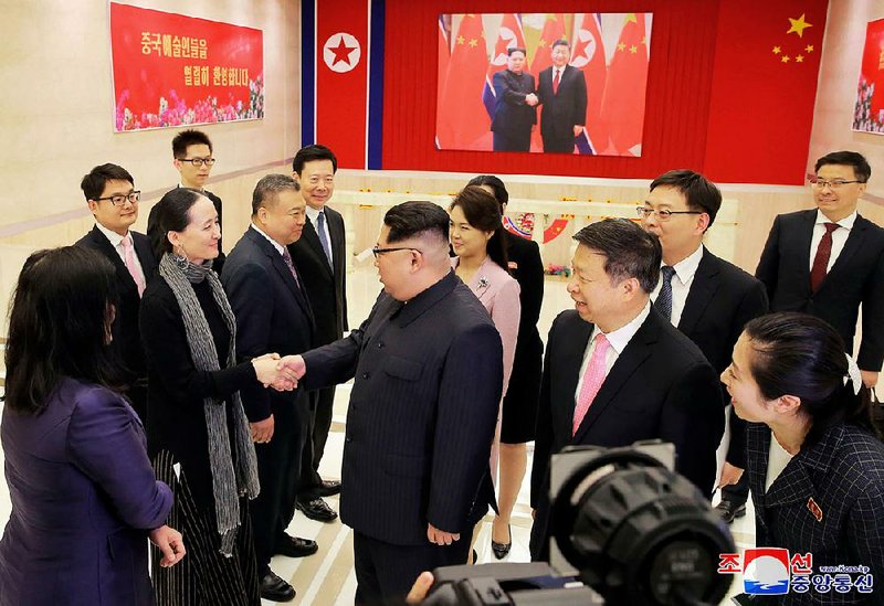 North Korean leader Kim Jong Un (center) greets members of a Chinese art troupe Saturday in Pyongyang as Song Tao (center right), a Chinese diplomat, looks on in this photo provided Sunday by the North Korean government.