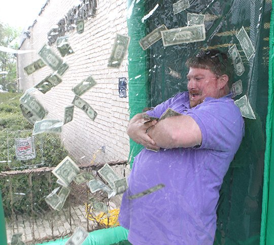 Johnathon Pope of Benton grabs cash in a cash machine Friday, April 13, 2018, at The Sentinel-Record. (The Senitnel-Record/Richard Rasmussen)