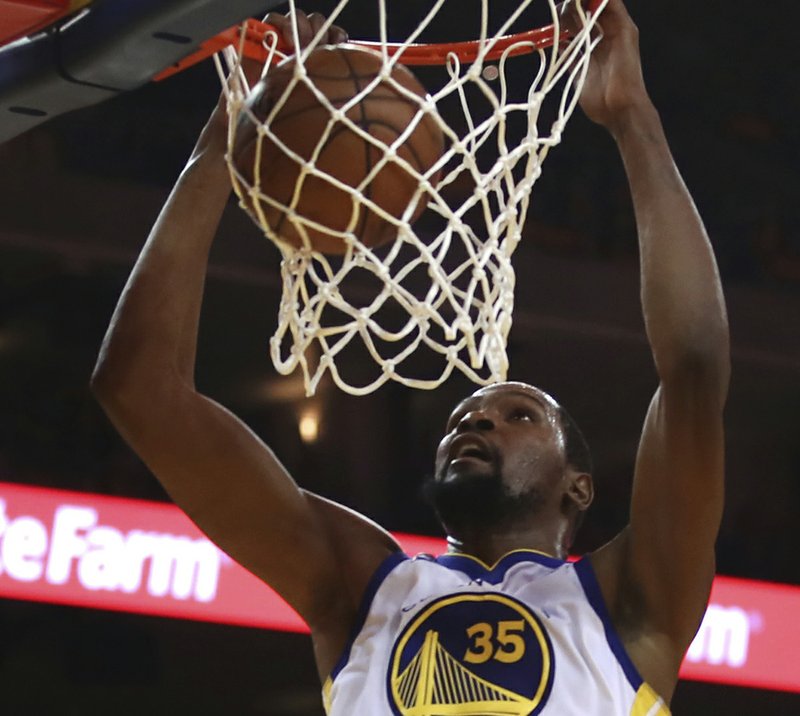 Golden State Warriors' Kevin Durant scores against the San Antonio Spurs during the first half in Game 1 of a first-round NBA basketball playoff series Saturday, April 14, 2018, in Oakland, Calif. (AP Photo/Ben Margot)