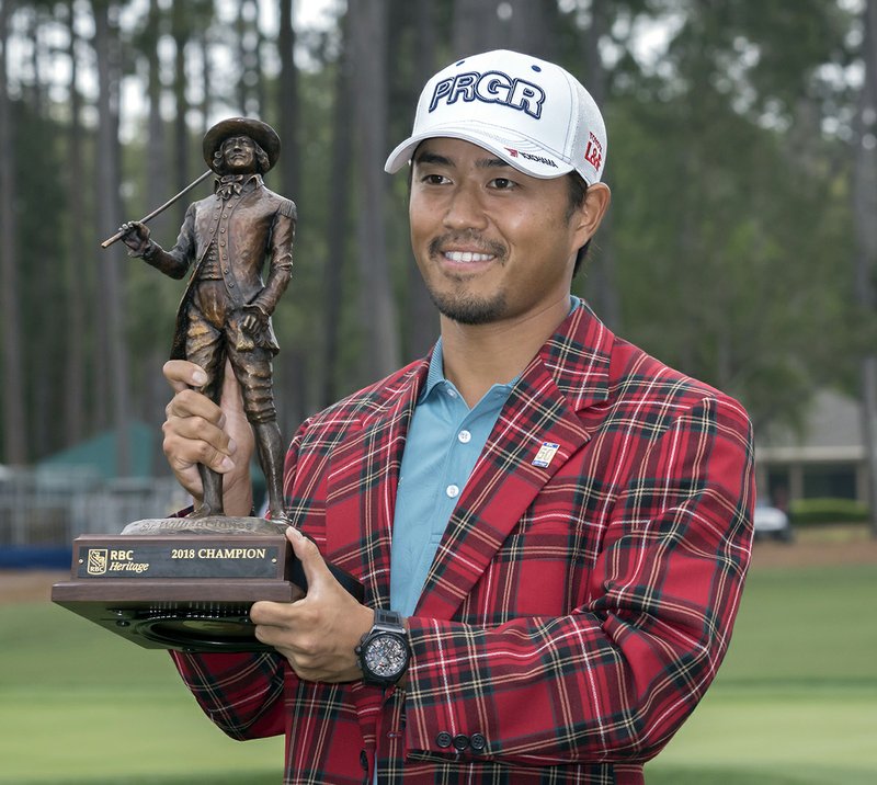 Satoshi Kodaira, of Japan, holds the trophy after winning the RBC Heritage golf tournament in a three-hole playoff against Si Woo Kim, of South Korea, during the final round of the tournament in Hilton Head Island, S.C., Sunday, April 15, 2018. (AP Photo/Stephen B. Morton)