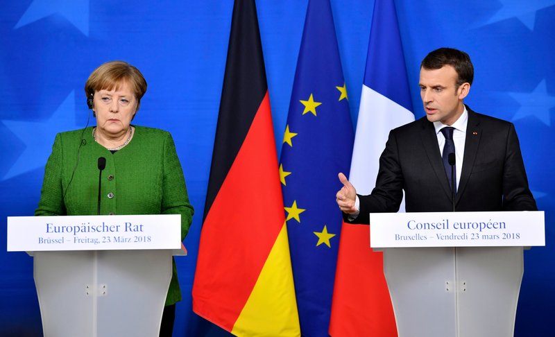 In this March 23, 2018, file photo, French President Emmanuel Macron, right, and German Chancellor Angela Merkel speak at a news conference in Brussels.  