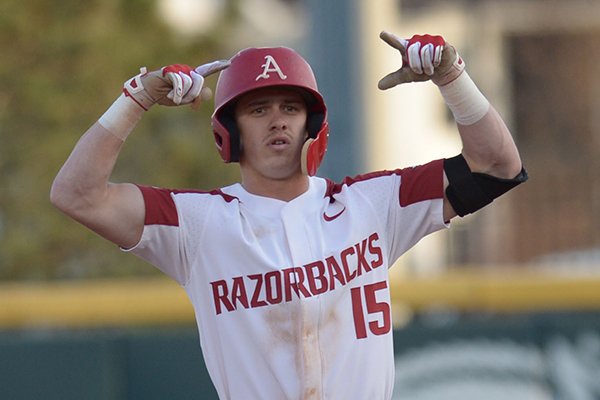 Arkansas third baseman Casey Martin celebrates Thursday, April 12, 2018, after hitting a double after which a run scored during the third inning against South Carolina at Baum Stadium in Fayetteville.