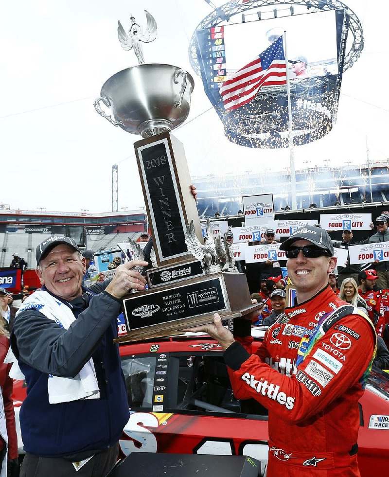 Kyle Busch (right) holds the winner’s trophy with Food City President and CEO Steve Smith after Monday’s NASCAR Monster Energy Cup race in Bristol, Tenn.