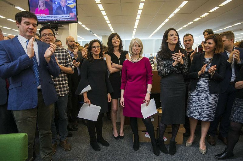 New York Times staff writers (beginning third from left) Jodi Kantor and Megan Twohey, senior enterprise editor Rebecca Corbett and reporter Cara Buckley celebrate with colleagues in the newsroom in New York after the reporting team won the 2018 Pulitzer Prize for Public Service on Monday.