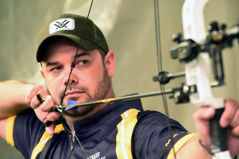Richard Bowen eyes a target during a practice session in March at the Outdoor America indoor archery range in Springdale. Bowen, who lives near Rogers, is one of the top target archers in the United States.