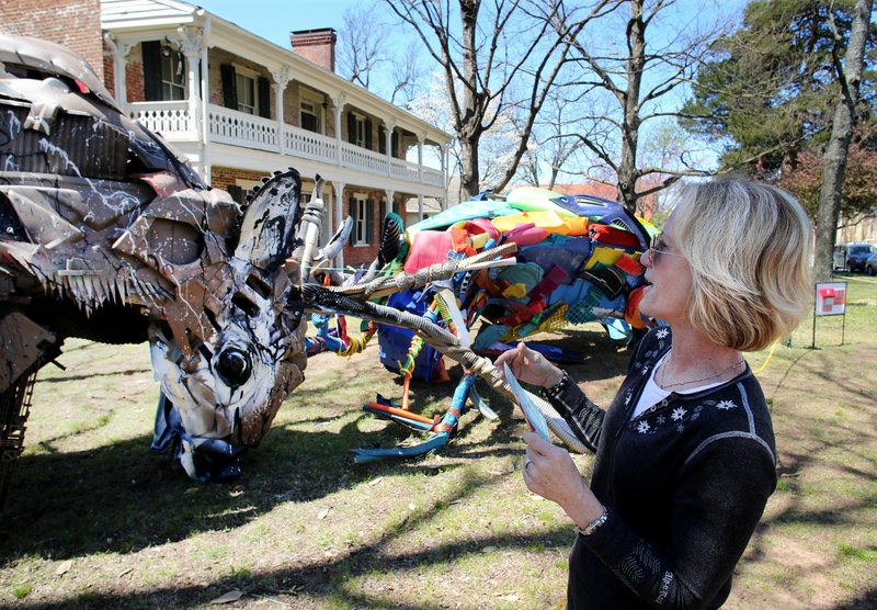 Marienne Brown of Kansas City, Kan., looks Monday at the three-dimensional piece by Portuguese multimedia artist Bordalo II at the Walker-Stone House in downtown Fayetteville. Brown was in Fayetteville visiting her daughter who attends the University of Arkansas.