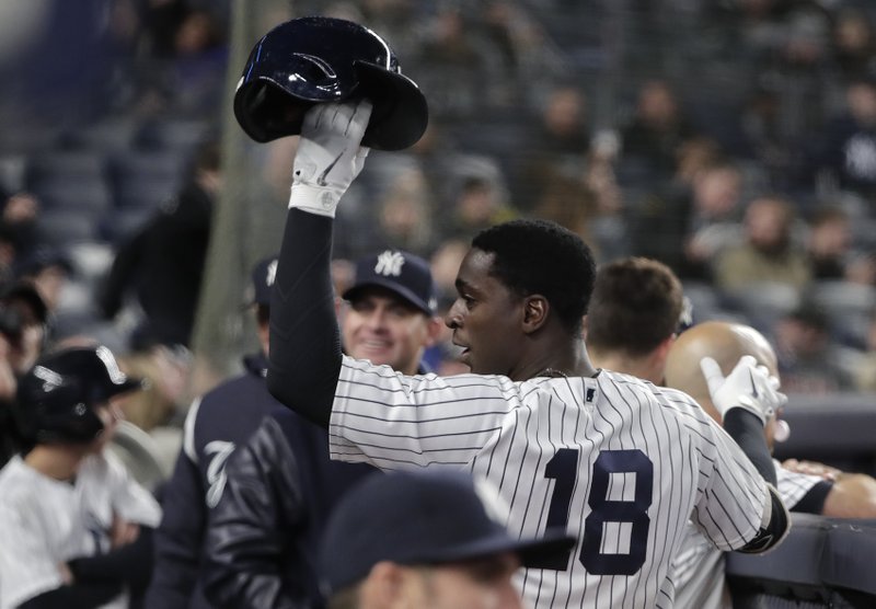 New York Yankees' Didi Gregorius (18) raises his batting helmet to the crowd after hitting a solo home run, his second of the game, against the Miami Marlins during the seventh inning of a baseball game, Monday, April 16, 2018, in New York. (AP Photo/Julie Jacobson)