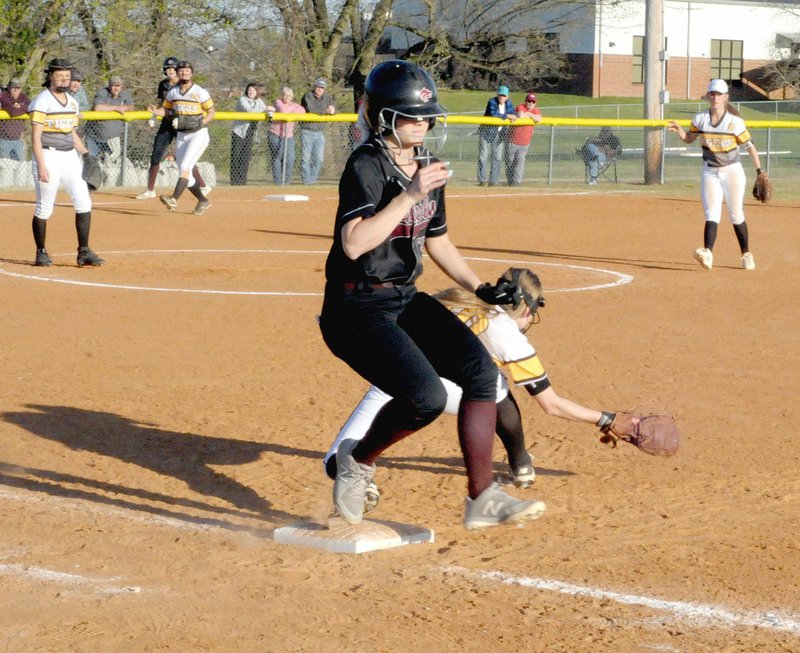 MARK HUMPHREY ENTERPRISE-LEADER Lincoln senior Hollie Webb was originally ruled out on this play with Prairie Grove first baseman Kylie Scott's foot on the bag while making a catch from shortstop. Lincoln coach Beau Collins appealed and the call was reversed with Webb gaining a two-out single RBI which tied the game at 2-2 in the bottom of the sixth. Lincoln's next batter, senior Tristan Cunningham, blasted a grand-slam home run to end the game with the Lady Wolves prevailing, 6-2.