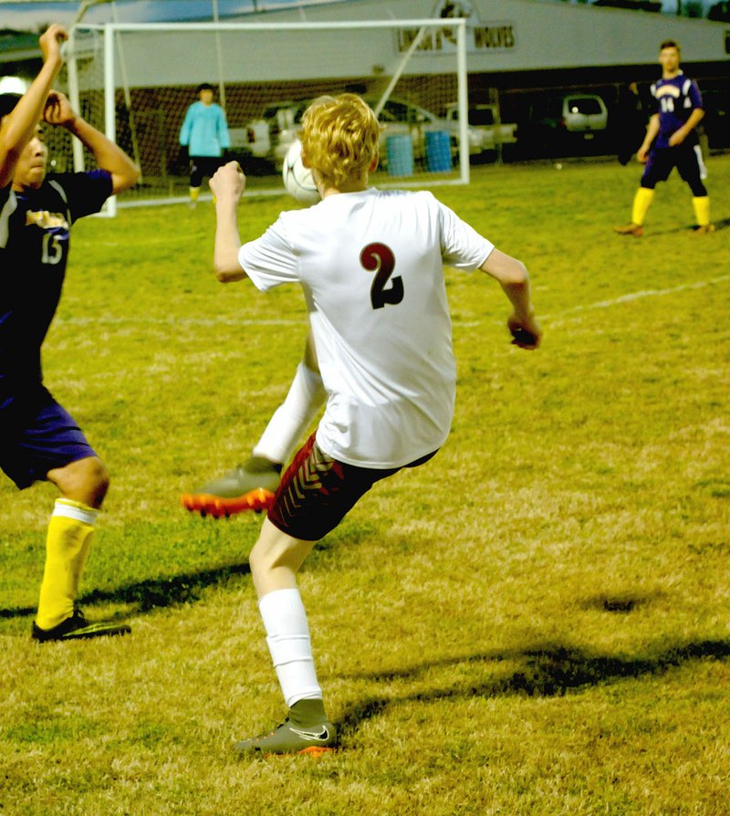 MARK HUMPHREY ENTERPRISE-LEADER Lincoln's Andrew West (shown kicking) set up a goal with an assist to Edson Cuevas in the first four minutes to put the Wolves up 1-0 early. Lincoln won the school's first-ever boys soccer victory with a 2-0 victory over Westville, Okla. on Monday, April 9. The second goal by Cameron Brown, Jr., didn't come until only 2:50 remained in the second half.