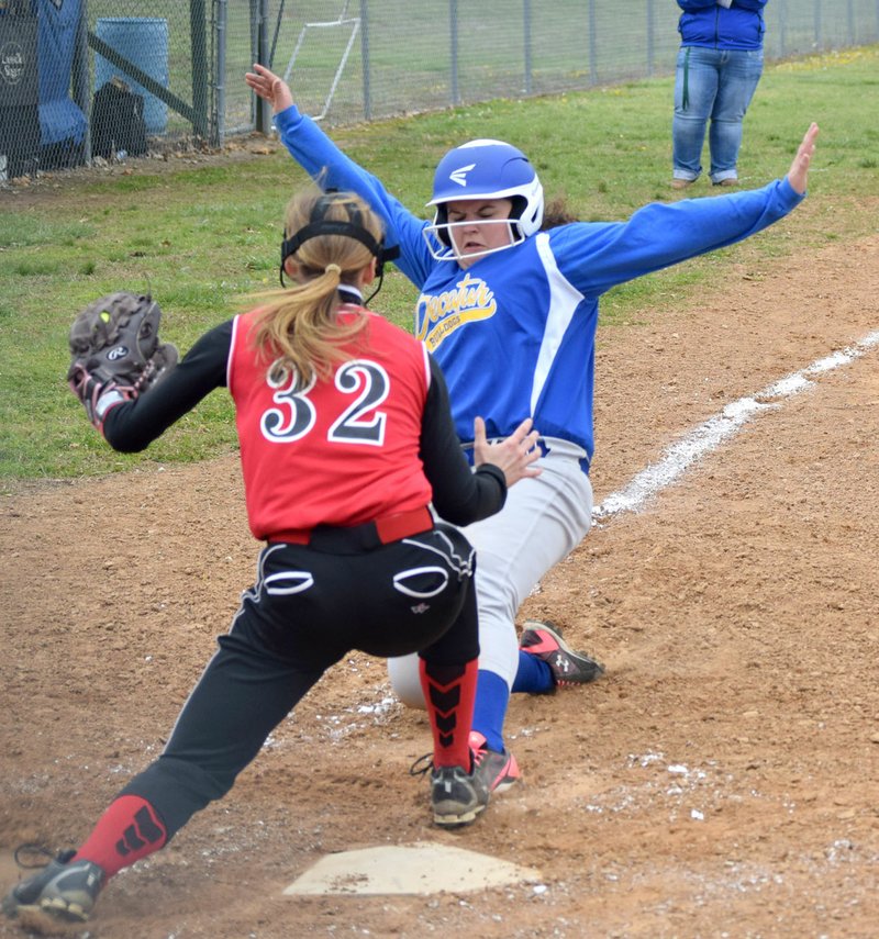 Westside Eagle Observer/MIKE ECKELS Lady Bulldgos' Paige Barrett tries to slide into home plate but catcher Bailey Reynolds (Deer 32) tags her out during the Decatur-Deer softball game in Decatur April 9.