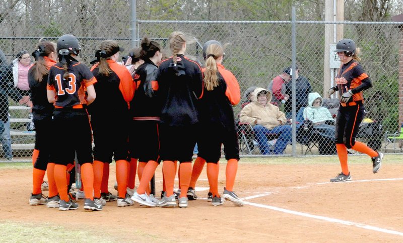 MARK HUMPHREY ENTERPRISE-LEADER/Gravette junior Sumer Kaba is greeted by her teammates after leading off the fourth inning with a solo homer. The next batter, senior Jaki Chalk, replicated the feat as Gravette took a 3-2 lead, but the Lady Lions were beaten 6-5 in eight innings at Lincoln on Monday, April 9.