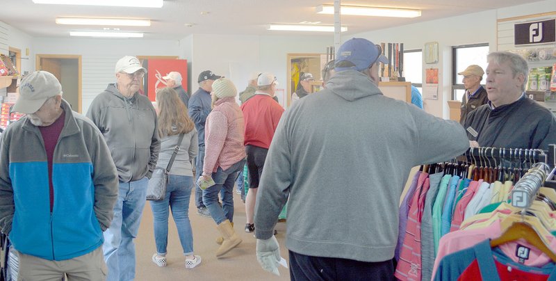 Keith Bryant/The Weekly Vista Several Golf Fest attendees took refuge from the cold in the pro shop at the Tanyard Creek practice area.