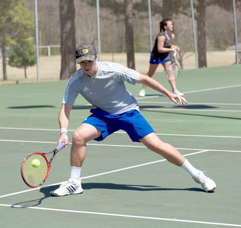 Photo courtesy of JBU Sports Information John Brown freshman Samuel Spencer plays a ball during the Golden Eagles' match against Southwestern Christian (Okla.) last Thursday at the JBU Tennis Complex.