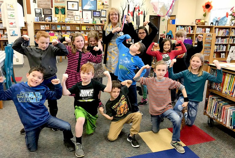 Photo submitted Lynn Paskiewicz, librarian at Southside Elementary School, and her students posed with her first place medal from the National Masters Weightlifting Championship on April 5. Paskiewicz lifted a total of 80 kg. (176.4 lbs.), qualifying her for the world championship in Barcelona, Spain.