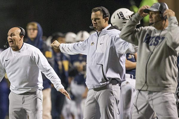 Bentonville West offensive coordinator Casey Dick, middle, is shown during a game against Conway on Thursday, Nov. 16, 2017, in Bentonville. Dick was hired Tuesday as head coach at Van Buren.