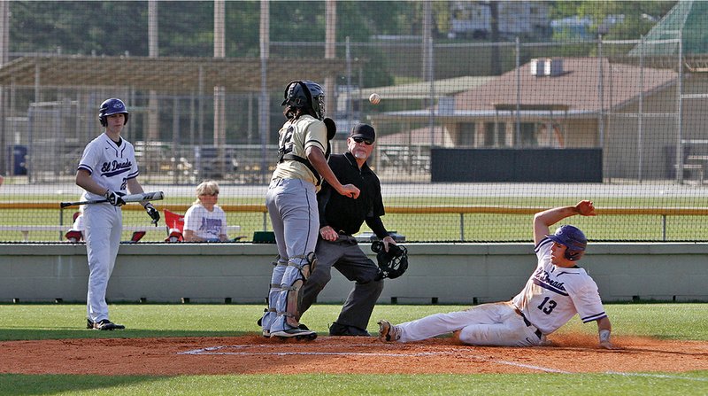 Terrance Armstard/News-Times El Dorado's Jacob Boshears slides safely across home plate during the Wildcats' contest against Hot Springs on Wednesday. Boshears later hit a three-run homer to guide the Wildcats to a 16-2 win over the Trojans.