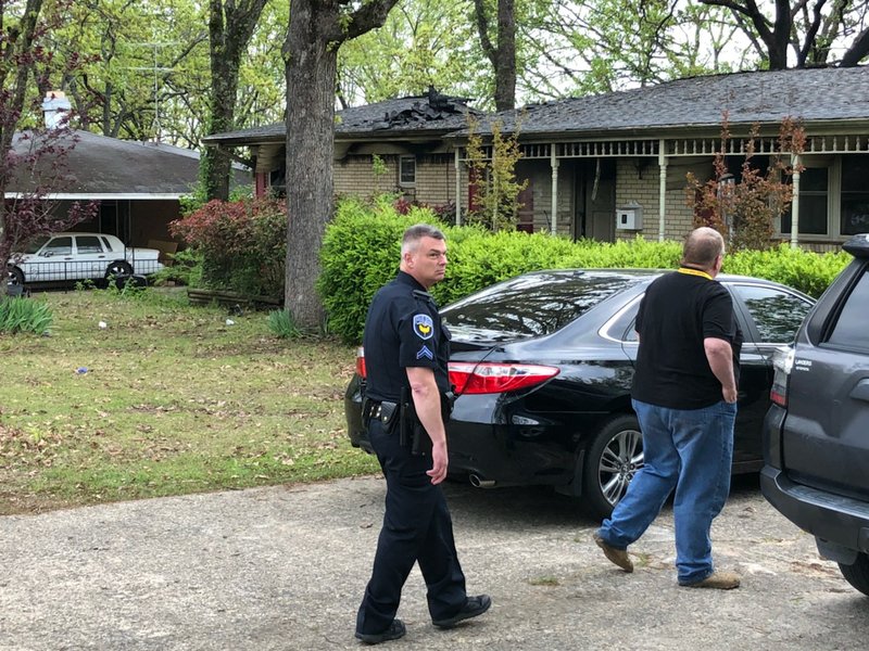 Authorities investigate at a North Little Rock house where three people were killed in a fire early Wednesday.