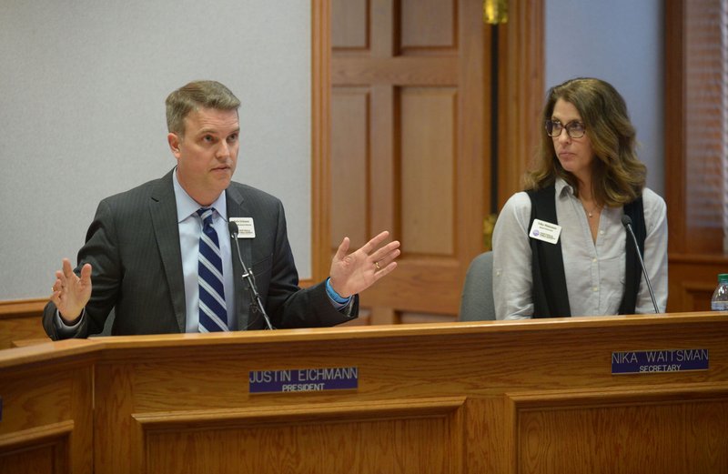 Justin Eichmann (left), president of the Fayetteville School Board, speaks Wednesday, April 18, 2018, alongside Nika Waitsman, board secretary, during a special meeting of the Fayetteville School Board at the Adams Leadership Center on the Fayetteville High School campus. The School Board voted to “further consider” a personnel matter that it discussed during an executive session.