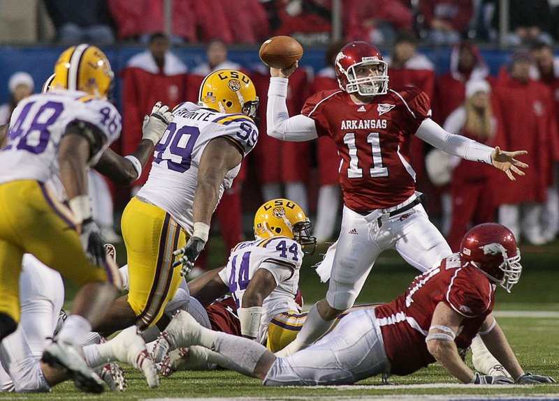 Arkansas quarterback Casey Dick throws a short pass to Dennis Johnson while under pressure from the LSU defense in the fourth quarter in this 2008 file photo.
