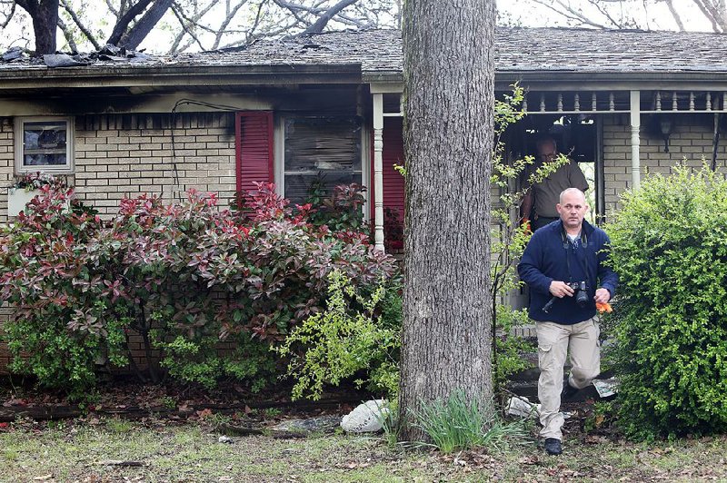 An investigator leaves the house at 5624 Alta Vista Drive in North Little Rock where a fire Wednesday killed three men and sent a 17-year-old boy to the hospital. 