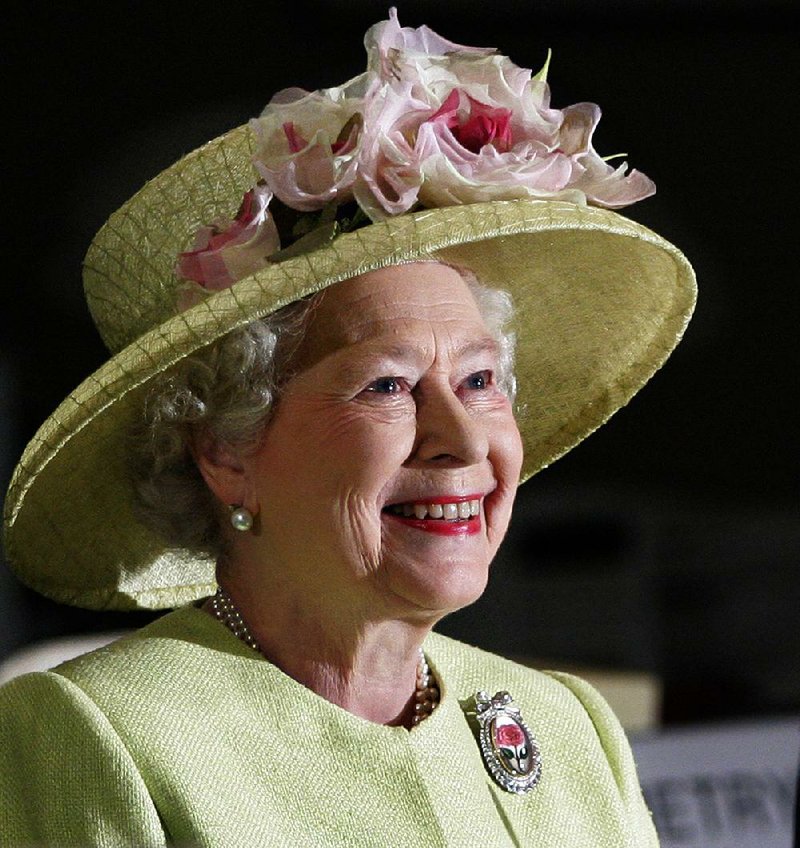 In this May 8, 2007 file photo, Britain's Queen Elizabeth II smiles as she is greeted by astronauts aboard the International Space Station, via video conference, during her visit to NASA's Goddard Flight Center in Greenbelt, Md..  O