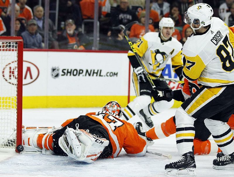 Pittsburgh’s Sidney Crosby (87) watches his shot glance off the post Wednesday in the Penguins’ 5-0 victory over Philadelphia. Crosby scored in the second period to help lead the Penguins to a 3-1 series advantage.  