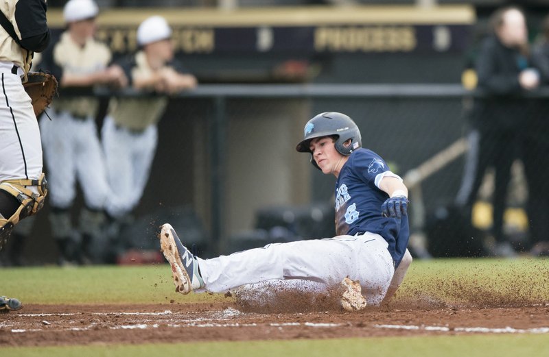 NWA Democrat-Gazette/CHARLIE KAIJO Springdale Har-Ber's Mac McCroskey (6) slides to home for a score during a 7A-West Conference baseball game at the Tiger Athletic Complex in Bentonville. McCroskey has been a table-setter at the top of the lineup this season for the league-leading Wildcats.