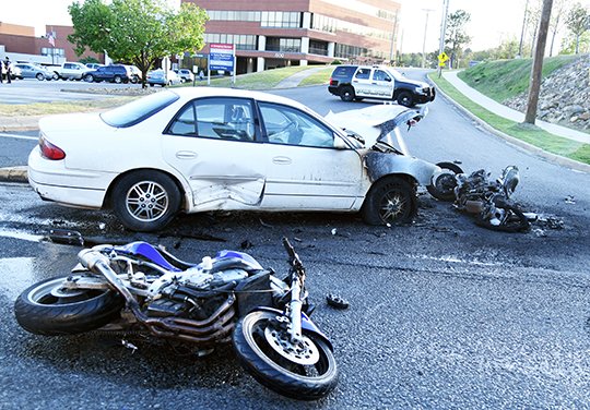 The Sentinel-Record/Grace Brown FATAL ACCIDENT: Two motorcycles lie in the street at the intersection of Malvern and Hollywood Avenues after colliding with a vehicle at around 6:35 p.m. Tuesday. One motorcyclist, Keido "Doc" Lovell Howard, was killed, while the driver of the car and the other motorcyclist were injured.