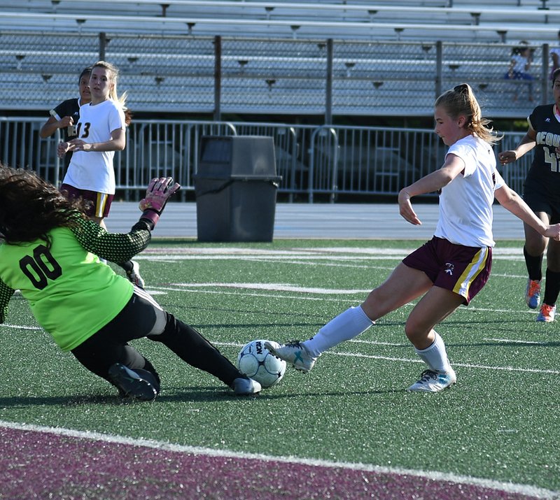The Sentinel-Record/Grace Brown SLIP-N-SLIDE: Lake Hamilton's Allison Irwin (8) goes for the goal as De Queen's goalkeeper Natalie Martinez (00) slides to kick it out of reach during Tuesday's game at Wolf Stadium. The Lady Leopards rallied late to outscore the Lady Wolves, 4-2.