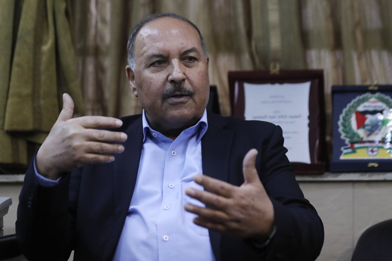 In this picture taken on Tuesday, April 17, 2018, Khaled Abdul-Majid, a leader of Palestinian Resistance Factions Coalition speaks during an interview with The Associated Press in Damascus, Syria. Syrian troops and pro-government Palestinian gunmen have been sending reinforcements and fortifying their positions around a refugee camp held by the Islamic State group south of the capital Damascus in preparations for an all-out offensive against the extremists if negotiations for their departure from the area fails. (AP Photo/Hassan Ammar)