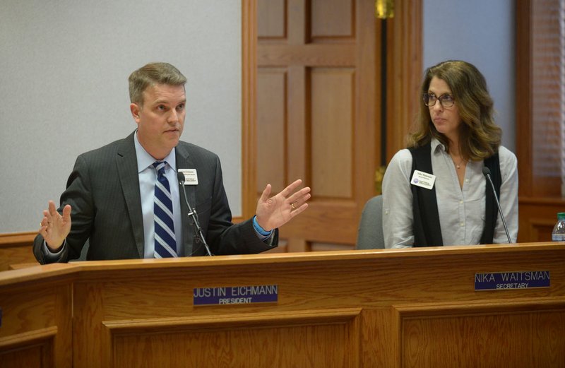 NWA Democrat-Gazette/ANDY SHUPE Justin Eichmann (left), Fayetteville School Board president, is shown in this file photo alongside Nika Waitsman, board secretary, during a special board meeting at the Adams Leadership Center at Fayetteville High School. 
