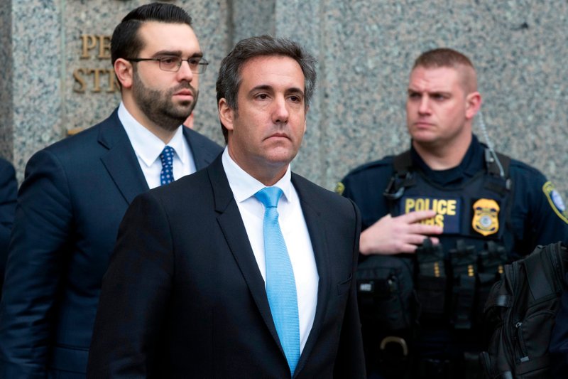 FILE - In a Monday, April 16, 2018, file photo, Michael Cohen, President Donald Trump's personal attorney, center, leaves federal court, in New York. Federal prosecutors said they can give President Donald Trump's personal lawyer, Cohen, copies of materials seized from him by the FBI by May 11. They notified a New York judge Wednesday. (AP Photo/Mary Altaffer, File)