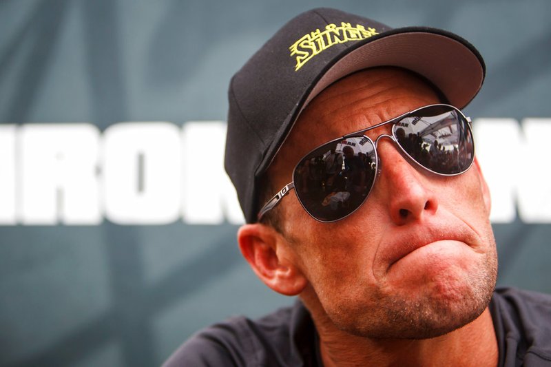 In this April 1, 2012 file photo, Lance Armstrong listens during a news conference in Galveston, Texas. Armstrong, on Thursday, April 19, 2018, has reached a $5 million settlement with the federal government in a whistleblower lawsuit that could have sought $100 million in damages from the cyclist who was stripped of his record seven Tour de France victories after admitting he used performance-enhancing drugs throughout much of his career. (Michael Paulsen/Houston Chronicle via AP, File)