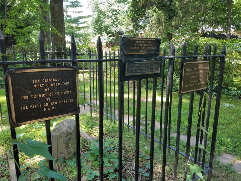 In this June 20, 2017 photo, various plaques note the work the Daughters of the American Revolution have done to preserve the West stone in Falls Church, Va. (William Vitka via WTOP)