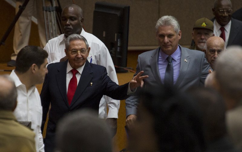 In this photo released by Cuba's state-run media Cubadebate, Cuba's President Raul Castro, center left, enters the National Assembly followed by his successor Miguel Diaz-Canel, center right, for the start of two-day legislative session in Havana, Cuba, Wednesday, April 18, 2018. The Cuban assembly selected the 57-year-old First Vice President as the sole candidate to succeed Castro on Wednesday, in a transition aimed at ensuring that the country's single-party system outlasts the aging revolutionaries who created it. 