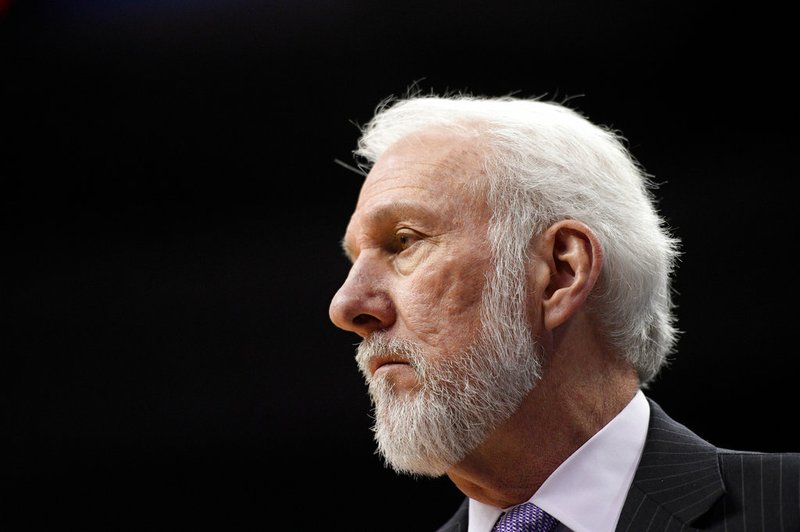 In this March 27, 2018, file photo, San Antonio Spurs head coach Gregg Popovich watches during the first half of an NBA basketball game against the Washington Wizards, in Washington.  The wife of Spurs coach Gregg Popovich has died. She was 67. The Spurs confirmed Erin Popovich's death Wednesday, April 18, 2018. The team didn't provide further details. (AP Photo/Nick Wass, File)