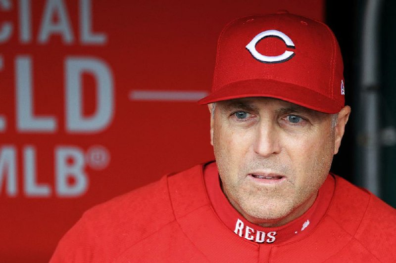 In this April 14, 2018, file photo, Cincinnati Reds' manager Bryan Price stands in the dugout prior to a baseball game against the St. Louis Cardinals, in Cincinnati. The Reds have fired Bryan Price after a 3-15 start, the first managerial change in the major leagues this season.