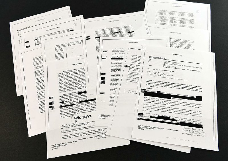 Copies of the memos written by former FBI Director James Comey are on display Thursday in Washington after 15 redacted pages were sent to lawmakers. 
